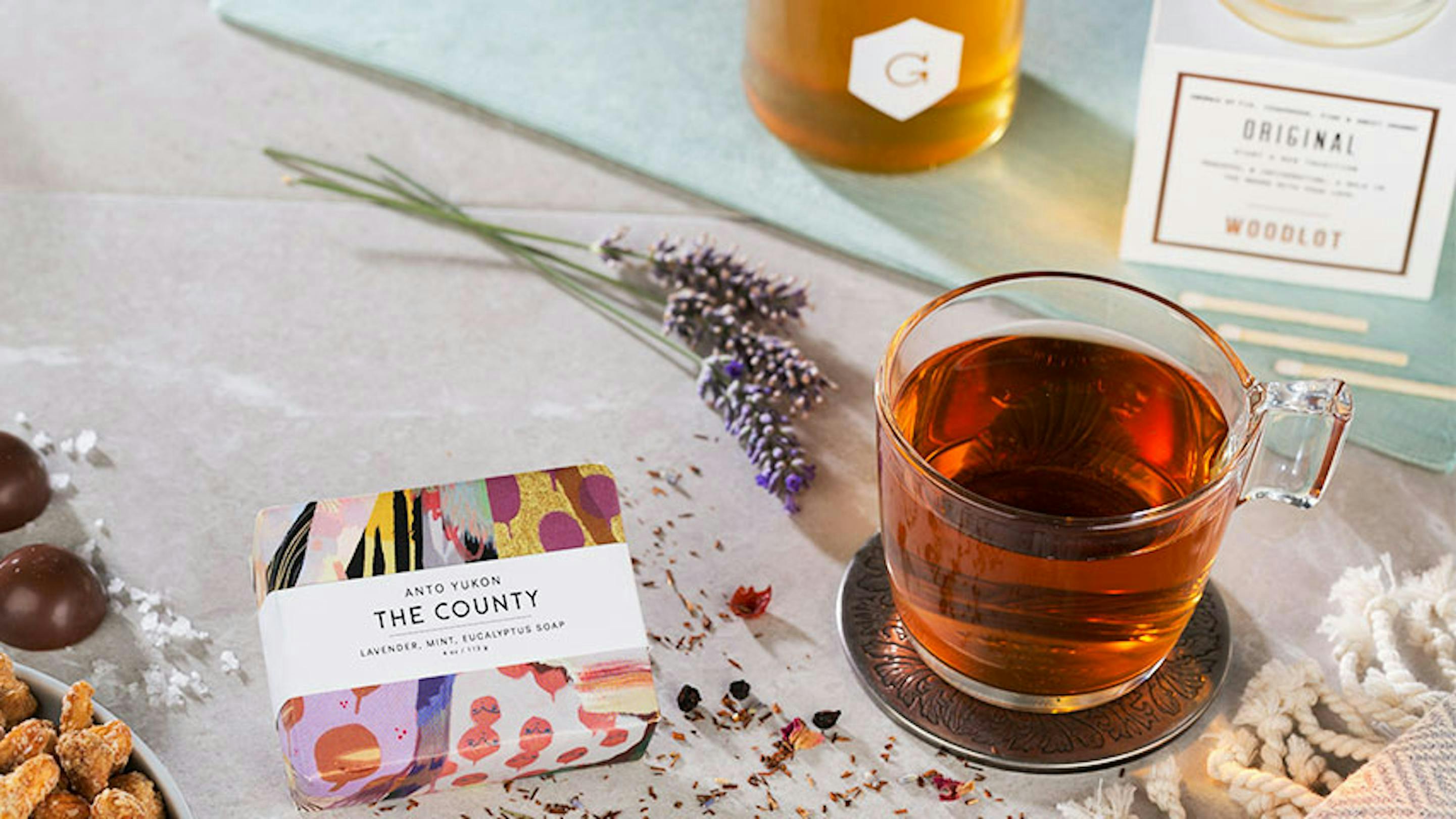 gifts for mom: chocolate, soap, tea, candle, honey and lavender on a table