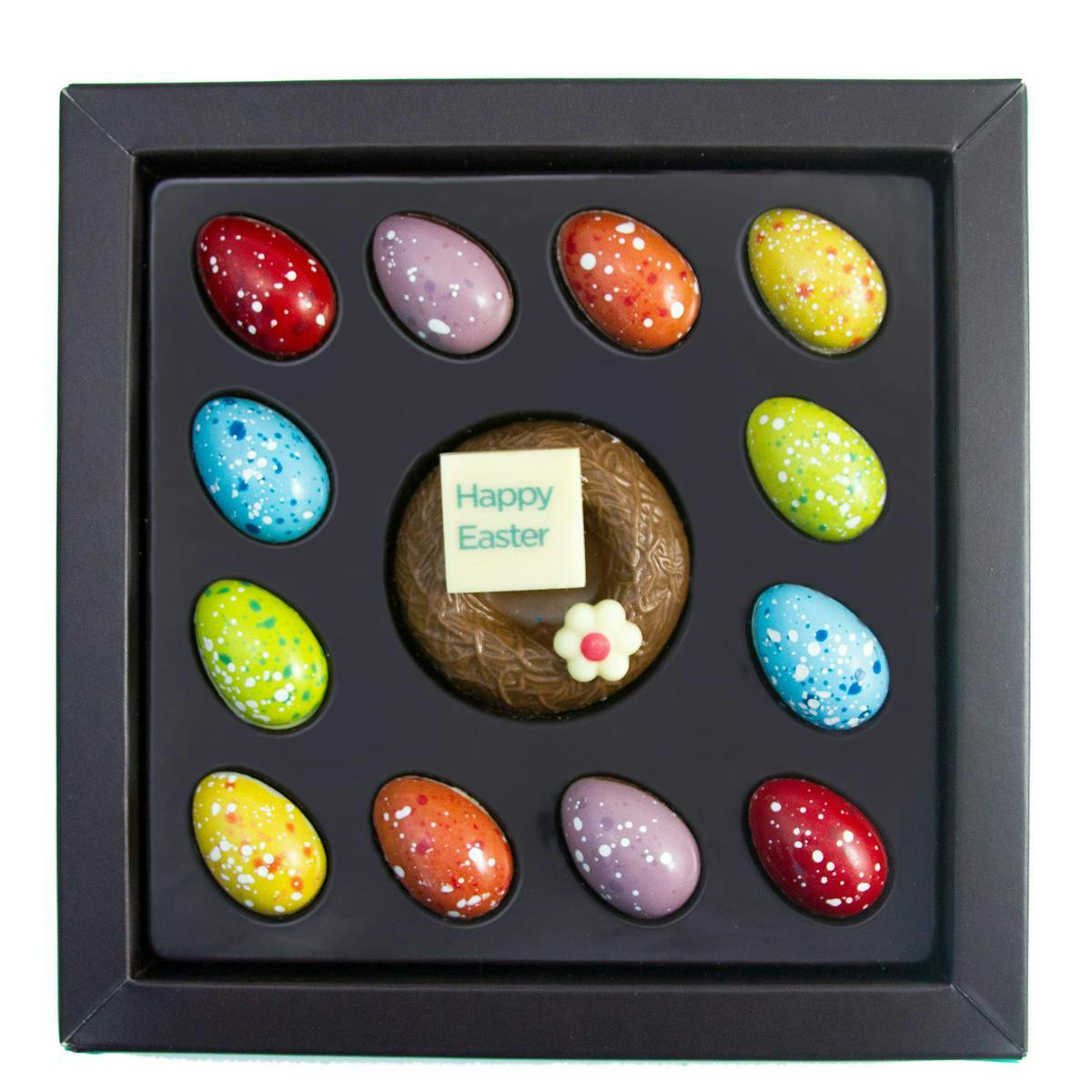 Colourful chocolate eggs in a square black box.